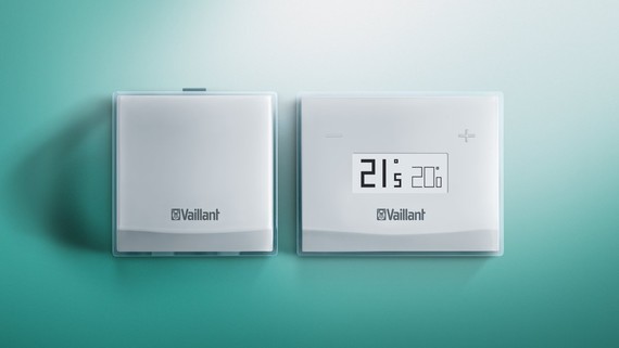 Vaillant vSmart smart thermostat on a white wall, showing the circular control and display